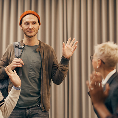 man waving to a new counseling group