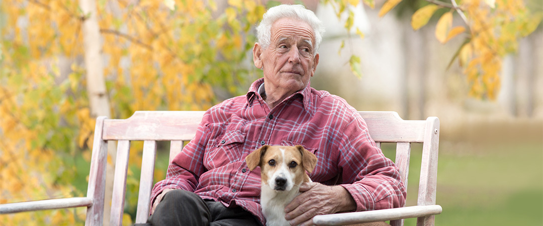 A man sitting with a dog